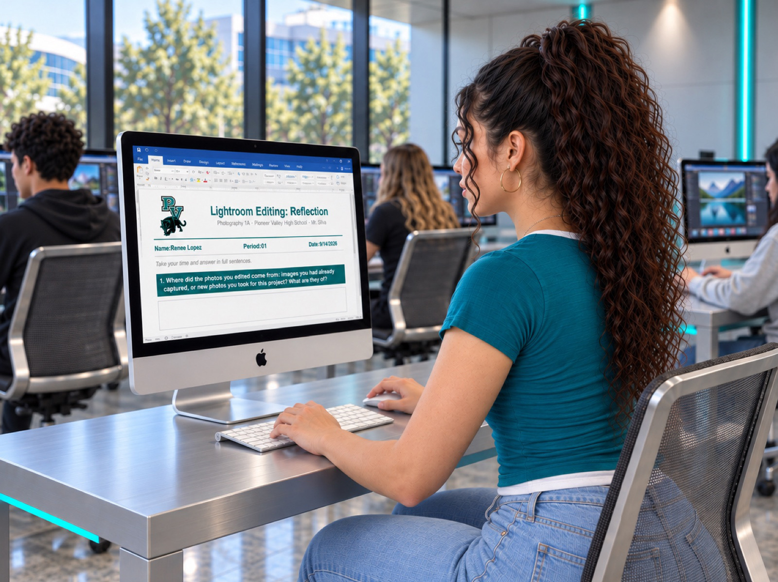 A Pioneer Valley student typing the Lightroom Editing reflection in the Word document on an iMac in the creative lab, with other students editing behind her