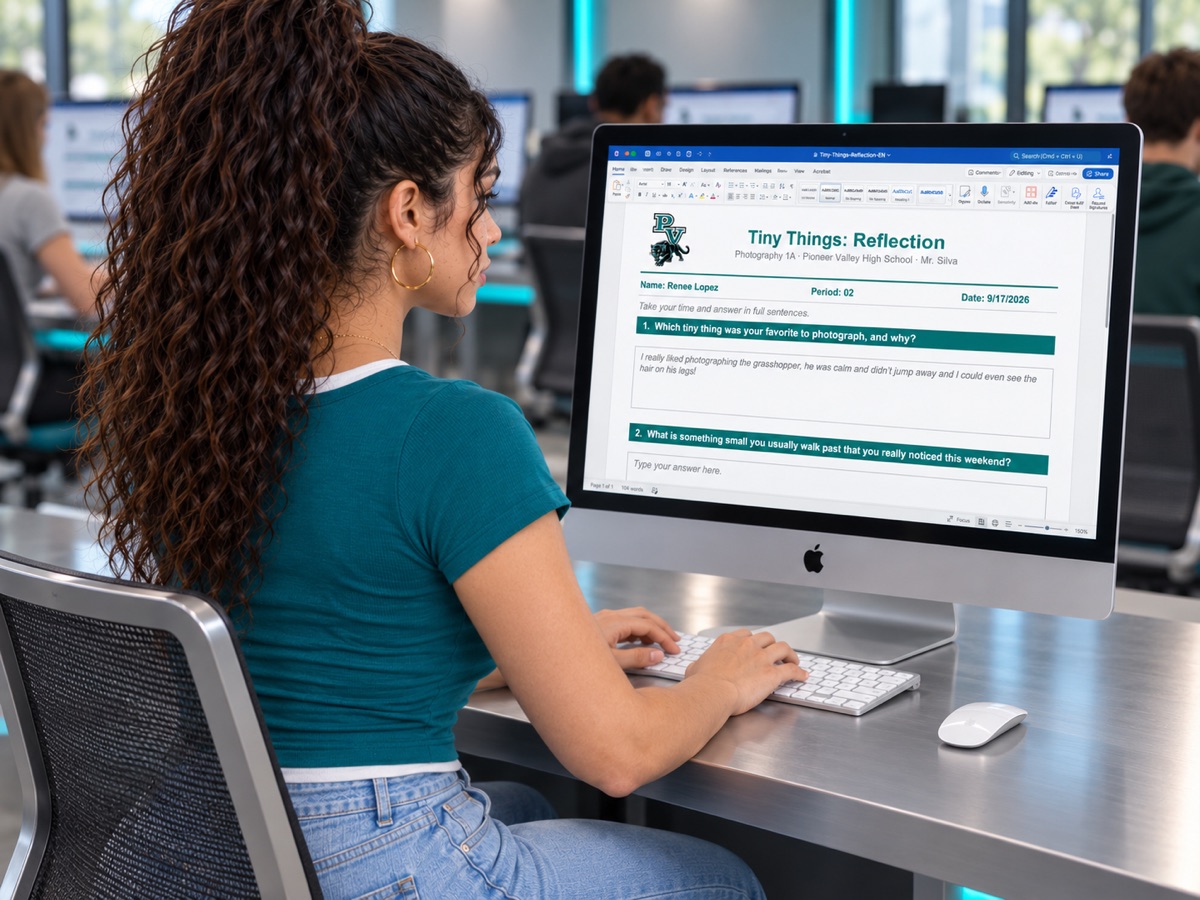 A student typing a short reflection on a lab computer